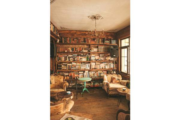 A cozy room filled with books and furniture.